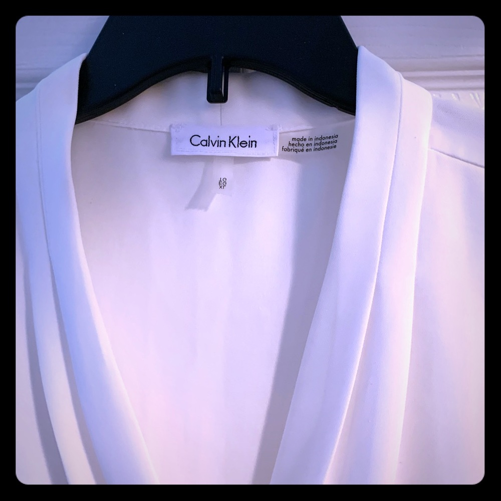 Sleeveless, timeless white Calvin Klein blouse.